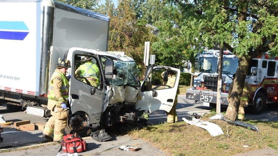 Two persons are rescued by firefighters after a single car collides with a tree